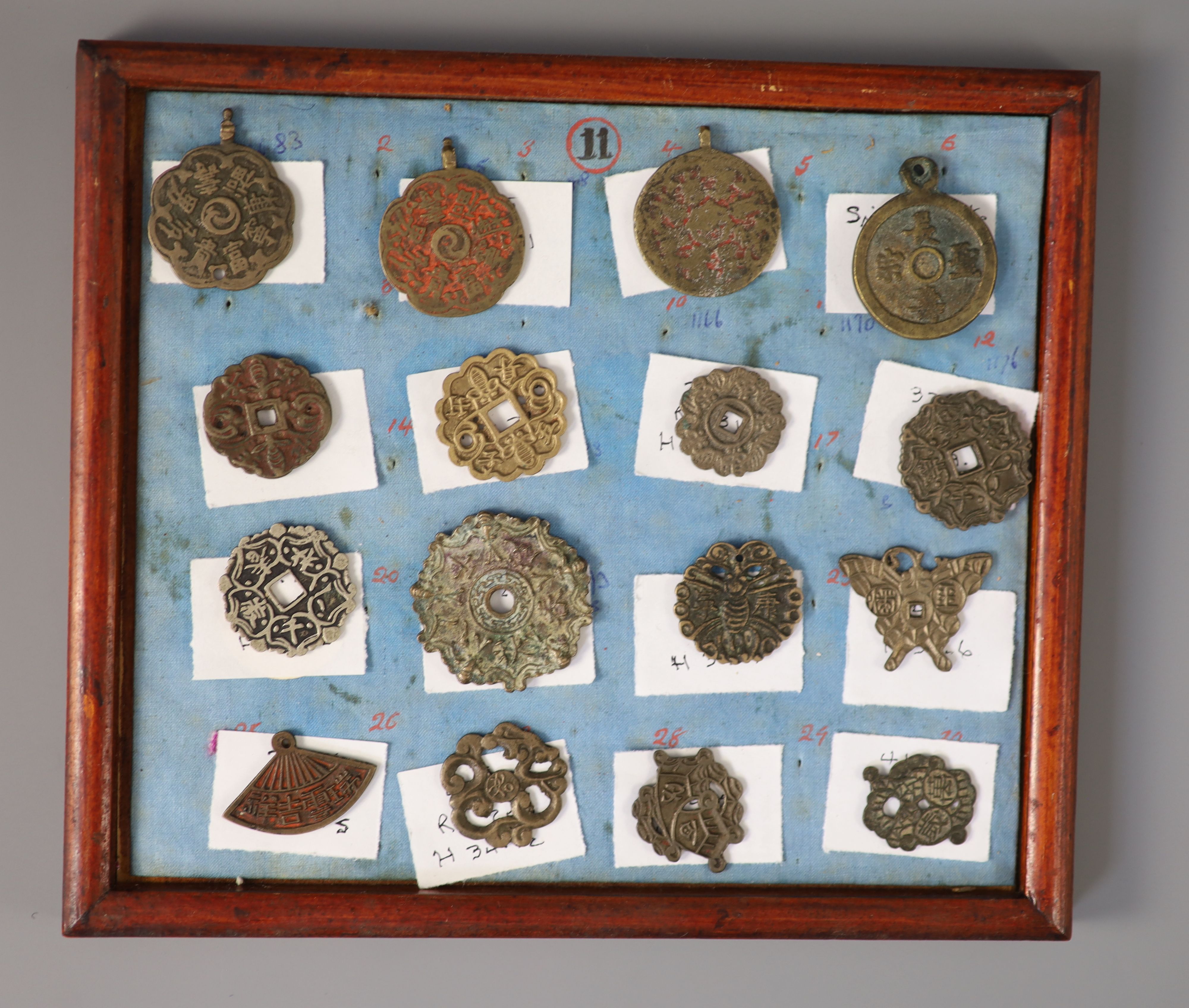 A group of 99 Korean bronze and metal amulets or charms, 19th/20th century